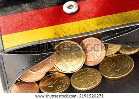 A purse with a German flag and many euro coins Royalty-Free Stock Photo #2191520271