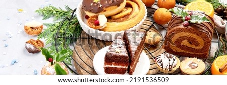 Delicious Christmas themed dinner table with roasted meat, potato, appetizers and desserts. Holiday concept. Top view on a grey background. Holiday concept. Panorama with copy space.