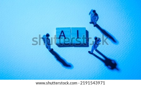 Miniature figures businessman : meeting on AI word by wooden block words on white paper background in blue light, ai is from artificial intelligence in concept of technology, business and futuristic.