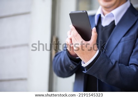 Businessman asian man looking at smartphone