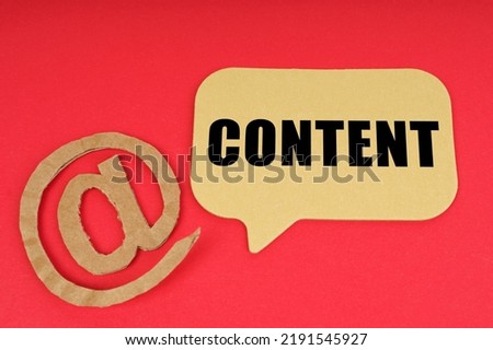 Email and business. On a red surface, a symbol and a sign with the inscription - Content