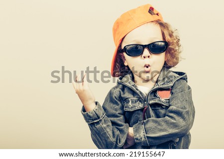 Fashion child. Happy boy model. Stylish little boy in baseball.  Handsome  kid  in the jeans jacket. Royalty-Free Stock Photo #219155647