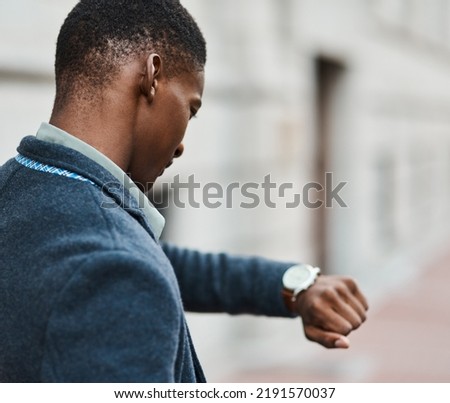 Running late, checking time on watch and feeling stressed, anxious and in hurry to get to work. Rushing entrepreneur in city, town or downtown missing a morning office appointment or public Royalty-Free Stock Photo #2191570037