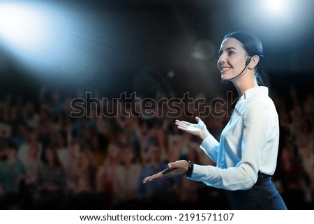 Motivational speaker with headset performing on stage Royalty-Free Stock Photo #2191571107