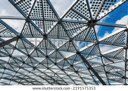Glass metal framed roof of a modern building. Abstract architectural background.