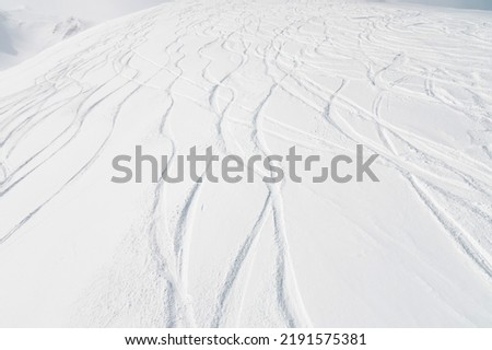 top view of the snow-covered slope of the mountain, traces from skiers and snowboarders, no people Royalty-Free Stock Photo #2191575381