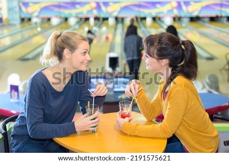 girls meeting at a bowling center