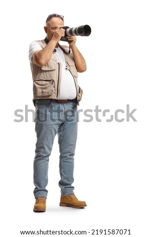 Full length shot of a mature man taking a photo with a professional camera isolated on white background