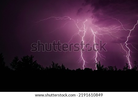 Thunderstorm in purple light. lightning at night.