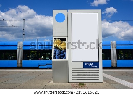 Tram stop in urban setting. ad panel. empty blank poster and advertising billboard sign. mock-up base. raster type business communication placeholder. sample image. modern blue tram in the background