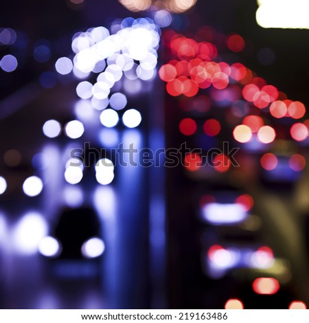 Blurred Defocused Lights of Heavy Traffic on a Wet Rainy City Road at 