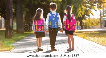 Cute little pupils going to school