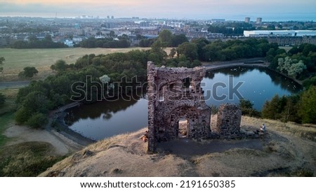 Ruin of St Anthony Chapel and Saint Margaret Loch in summer evening - drone photo