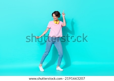 Full size photo of funky joyful crazy lady stylish outfit dance chill favorite playlist relax rest isolated on aquamarine color background