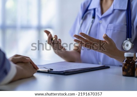 Smiling female doctor talking to woman in hospital Concept of counseling and giving advice on medicines to patients