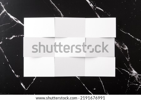 Photo of white business cards on black marble. Template for branding identity isolated on marble background. Business Card isolated on marble stone. 