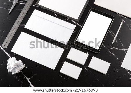 Photo of branding identity mock up on black marble. Template isolated on marble background. For graphic designers presentations and portfolios marble premium luxury mock-up
