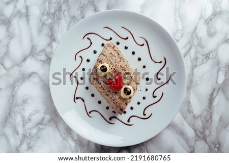 Board with delicious cake on table