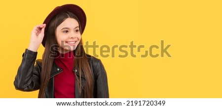 happy teen girl in hat and leather jacket, style. Child face, horizontal poster, teenager girl isolated portrait, banner with copy space.