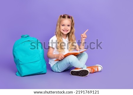 Full length photo of little pupil girl ponytails empty space homework backpack wear trendy white look isolated on purple color background Royalty-Free Stock Photo #2191769121
