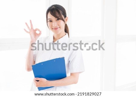 Young attractive asian nurse of the smile,Medical questionnaire