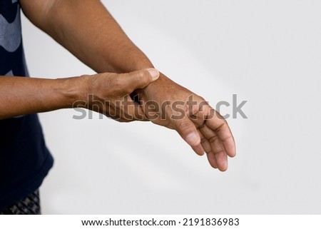 Closeup elderly hands  massage painful wrist. Concept : health problem. Senior healthcare.  Massage for relieve of  hurt or painful. Wrist symptomatic. Royalty-Free Stock Photo #2191836983