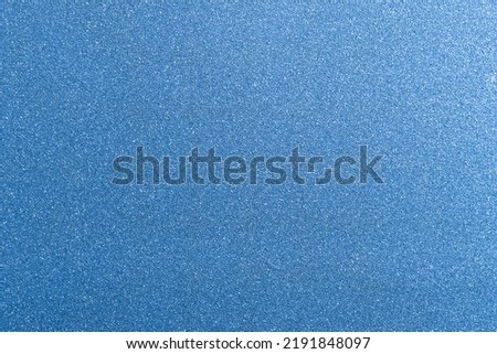 Blue panel with some fine grain in it. Blue glitter background