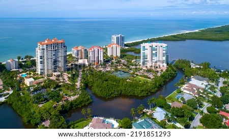 Aerial View of Real Estate in Naples with the Bay in the Foreground and the Blue Water of the Gulf of Mexico in the Background. Luscious Green Mangroves and a White Sand Beach Drone View Royalty-Free Stock Photo #2191851293