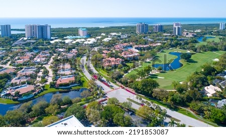 Aerial of Real Estate in Naples, Florida with a Golf Course in the Foreground and Mangroves with a Beach on the Gulf of Mexico in the Background. Drones Eye View Royalty-Free Stock Photo #2191853087