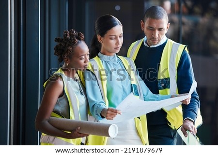 Construction, architect plans and diverse engineers consulting and planning a design as a team. Group of creative, professional and successful industry workers analyzing architecture documents. Royalty-Free Stock Photo #2191879679