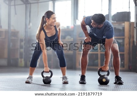 Strong, wellness couple doing kettlebell weight exercise, workout or training inside a gym. Happy sports people or trainer motivation, exercising with fitness equipment for muscle, strength or Royalty-Free Stock Photo #2191879719