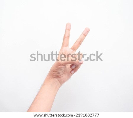 Caucasian thin man's hand making the two-finger sign or acceptance political sign style