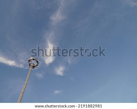 a lamppost against a beautiful cloudy blue sky background
