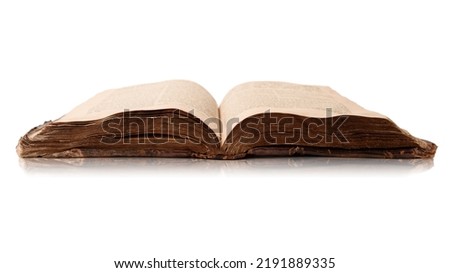 Single old worn jewish book. Open shabby pages of Torah isolated on white background with reflection. Closeup. Copy space. Selective focus Royalty-Free Stock Photo #2191889335