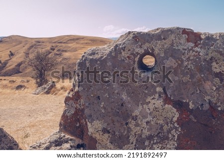 Megalithic standing stones and burial mound of Zorats Karer or Carahunge - prehistoric monument in Armenia. Armenian Stonehenge stock photo
