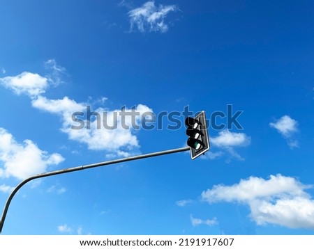 Car traffic light on blue sky background with copyspace