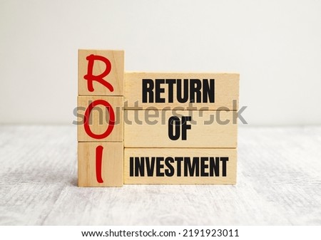 Return on Investment, ROI. Cube wooden block with alphabet building the word ROI. Royalty-Free Stock Photo #2191923011