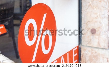 city your shopping time sale offers.red yellow color sale banner word on shop window glass.percent sign on clothes background.sidewalk reflection,black friday,buy mall time 