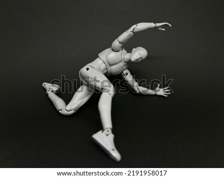 A figurine is jumping and kicking from a high place. Concept of combat sport and martial arts.