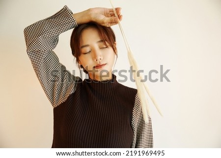 Portrait of a young Asian woman in autumn fashion
