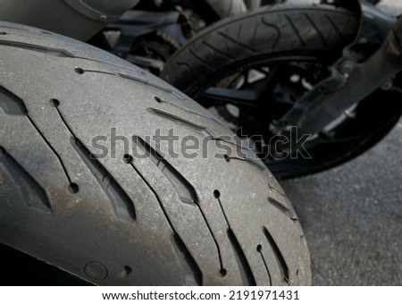 Closeup of worn motorcycle tire at a motorbike service center. Royalty-Free Stock Photo #2191971431
