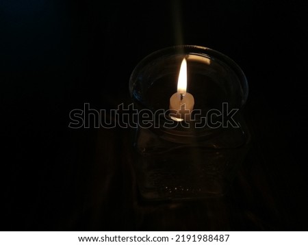 Candle light in the dark. Candle flame at night. Close up. Burning candle.