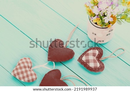 Romantic accessories and copy space on blue wooden background.