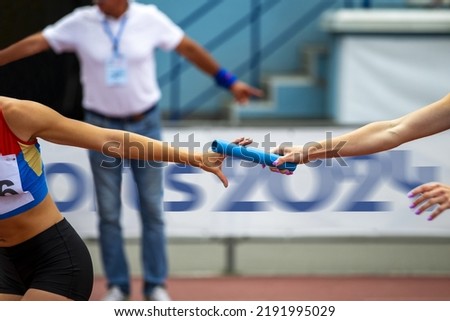 women relay race competition on background banner Sports 2024 Royalty-Free Stock Photo #2191995029