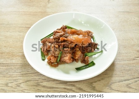 fried fermenting beef meat with pandan leaf on plate Royalty-Free Stock Photo #2191995445