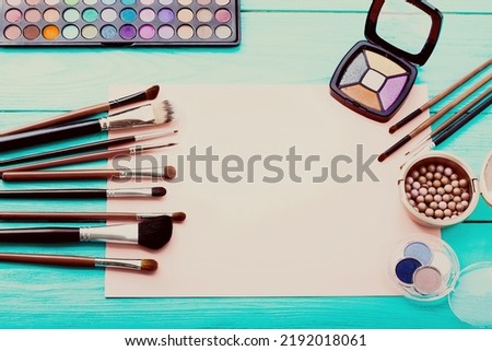Frame of cosmetic accessories on background with copy space. Top view