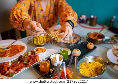 Indian food Curry butter chicken, Palak Paneer, Chiken Tikka, Biryani, Vegetable Curry, Papad, Dal, Palak Sabji, Jira Alu, Rice with Saffron on table. Royalty-Free Stock Photo #2192022217