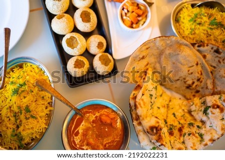 Indian food Curry butter chicken, Palak Paneer, Chiken Tikka, Biryani, Vegetable Curry, Papad, Dal, Palak Sabji, Jira Alu, Rice with Saffron on table. Royalty-Free Stock Photo #2192022231