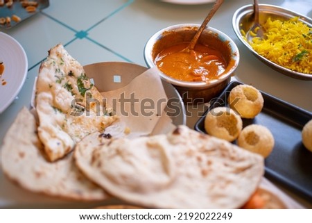 Indian food Curry butter chicken, Palak Paneer, Chiken Tikka, Biryani, Vegetable Curry, Papad, Dal, Palak Sabji, Jira Alu, Rice with Saffron on table. Royalty-Free Stock Photo #2192022249