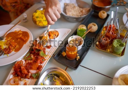 Indian food Curry butter chicken, Palak Paneer, Chiken Tikka, Biryani, Vegetable Curry, Papad, Dal, Palak Sabji, Jira Alu, Rice with Saffron on table. Royalty-Free Stock Photo #2192022253